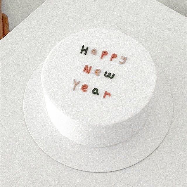 a white cake with the words happy new year written on it