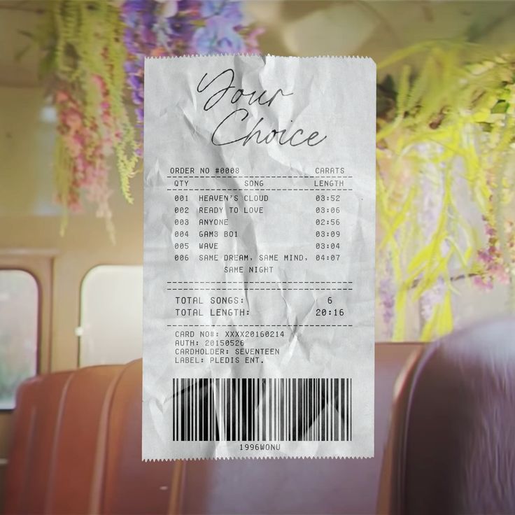 a ticket sitting on top of a chair next to a wall covered in purple flowers