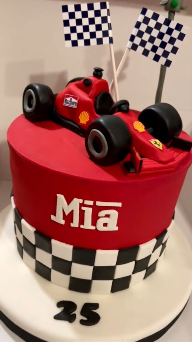 a red race car birthday cake with checkered flags