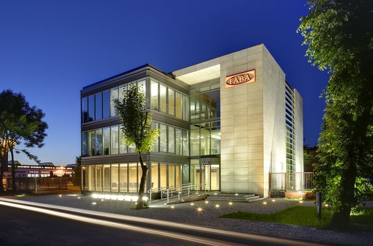 an office building lit up at night time