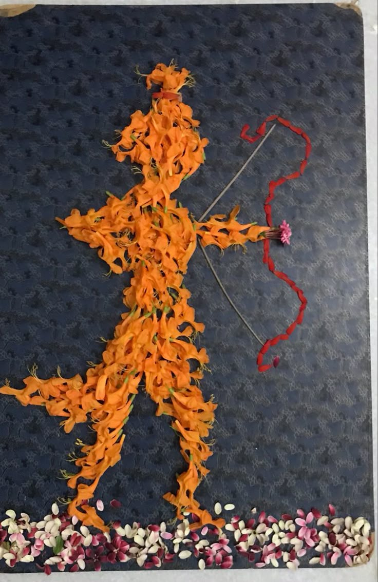 an image of a person made out of flowers and ribbons with the shape of a man holding a bow