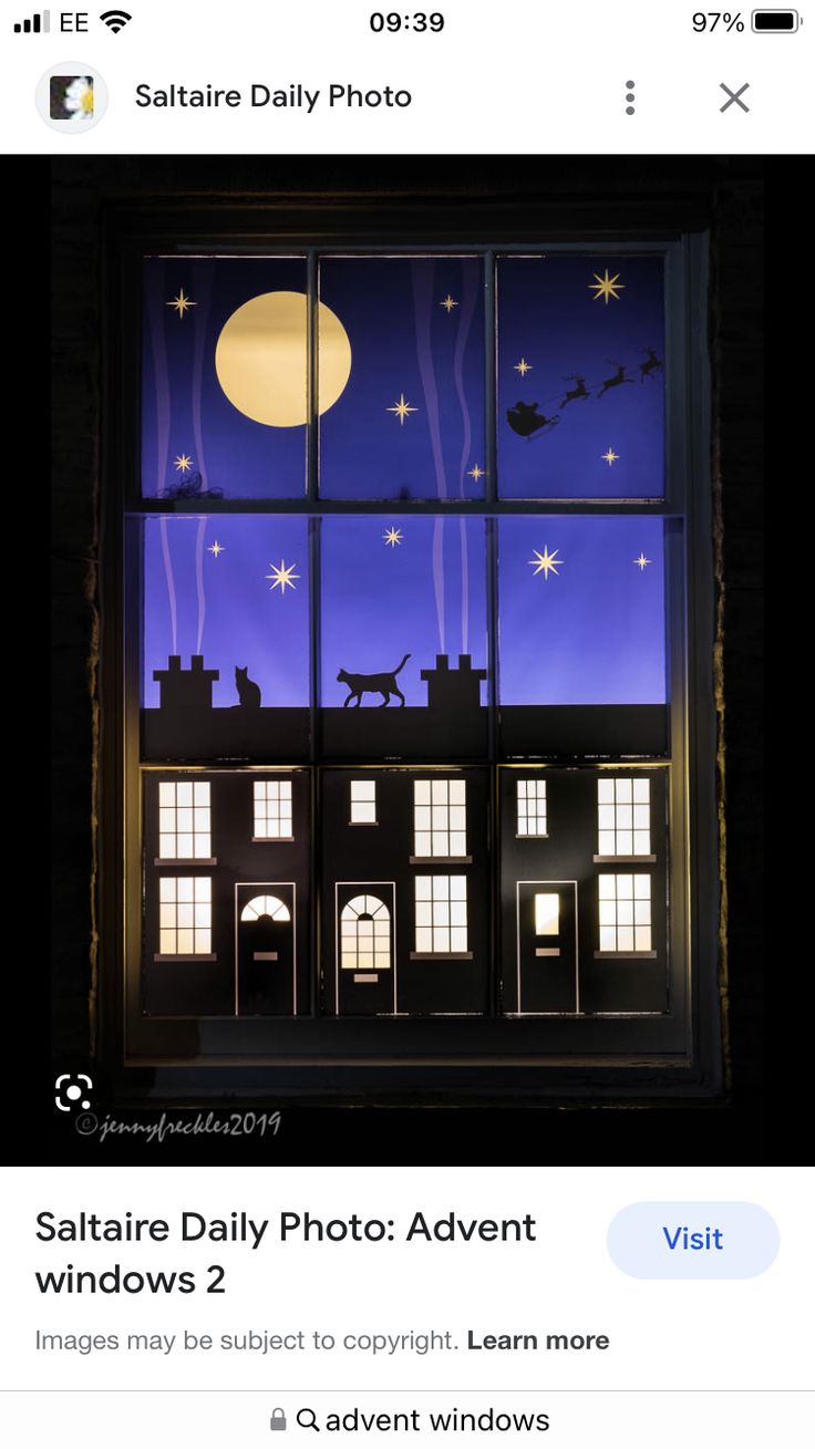 an image of a window that is lit up with the moon and stars above it