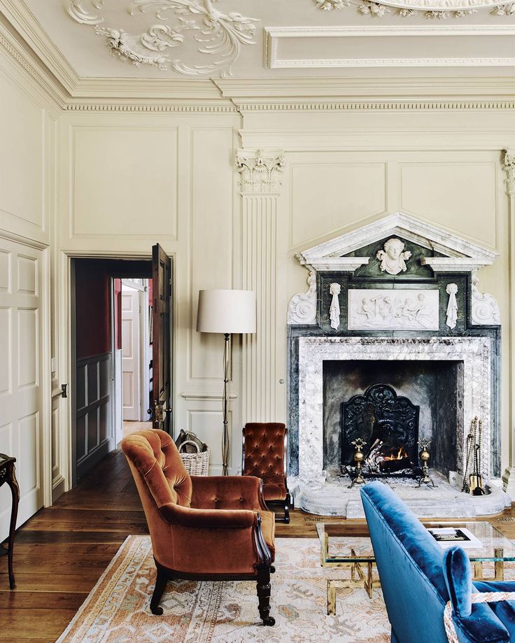 a living room filled with furniture and a fire place in the middle of a room