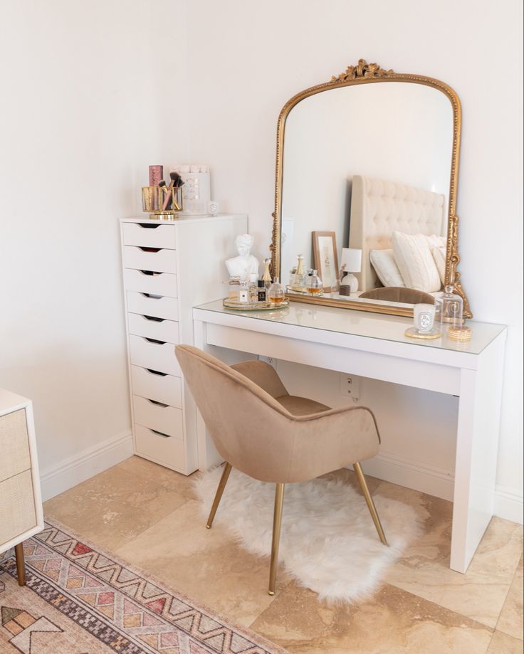 a white desk with a mirror, chair and drawers in a room that is well decorated