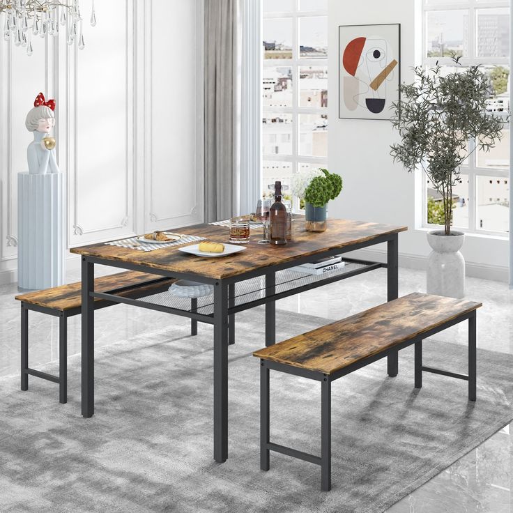 a dining room table with benches in front of it