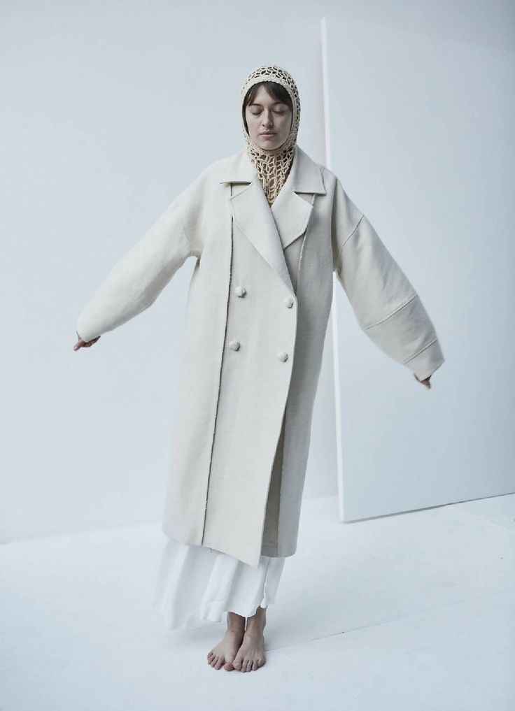 This sweeping statement coat exudes oversized elegance with its wide lapels leading to a romantic deep V neckline. Falling just above the ankles, the Snegurochka Cream Wool Hemp Shell Buttons Coat is both cozy and sophisticated. Made from a blend of durable hemp and wool fibers, its sturdy structure is punctuated with uniquely handcrafted ceramic shell buttons. Lined.Composition 40% Hemp 60% Wool and it´s undyed.Lining 100% viscoseTrimming 100% ceramic glazed handmade shell buttonsSizesOversize. Ceramic Shell, Cream Coat, Statement Coat, Handcrafted Ceramics, Shell Buttons, Women Artisans, A Romantic, Deep V, Shells