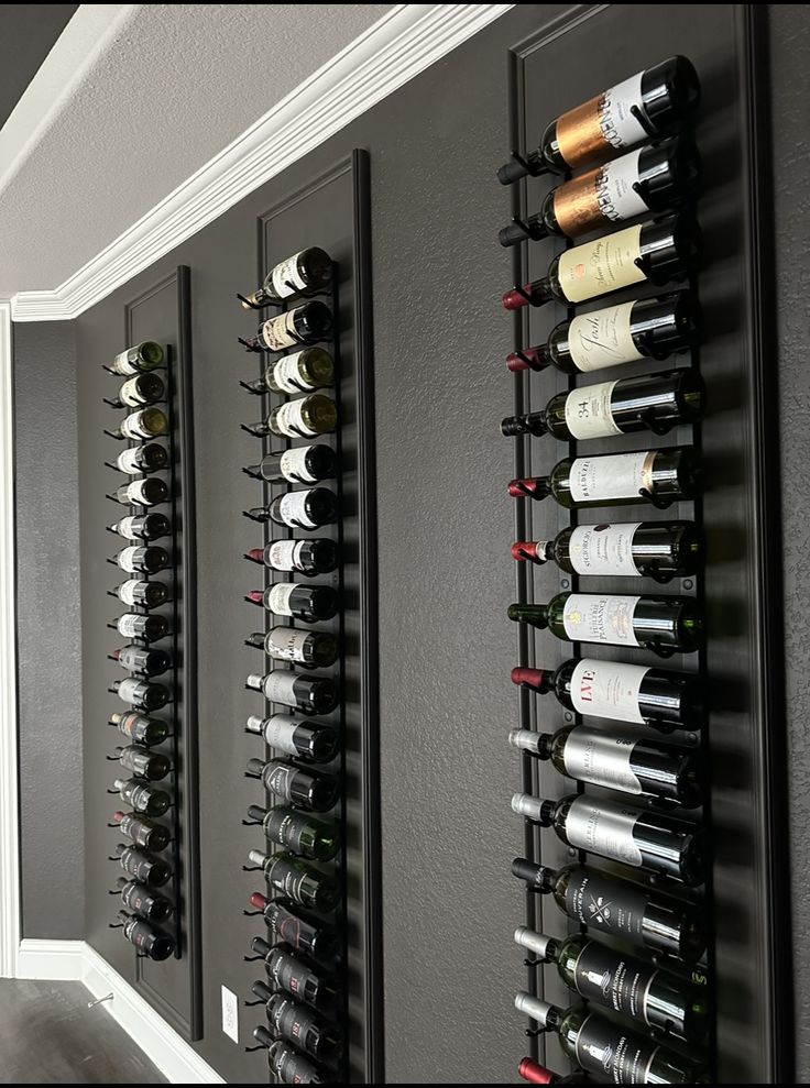 a wine rack with many bottles on it next to a wall mounted wine bottle holder