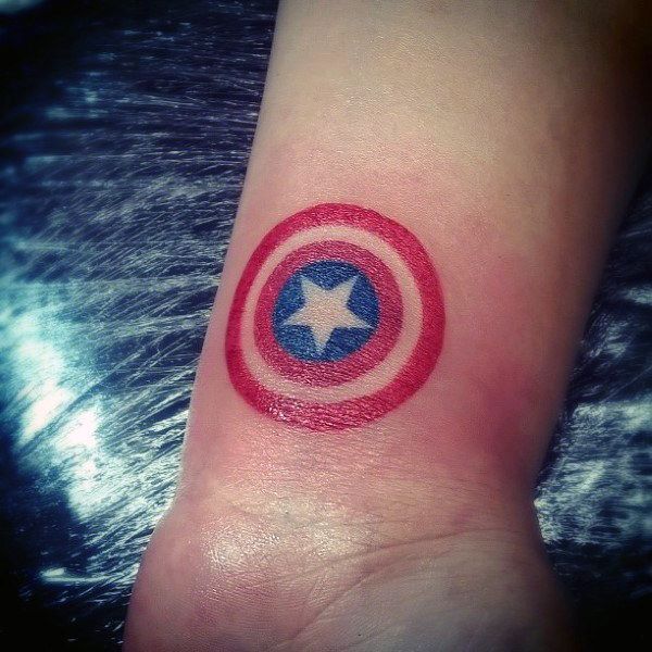 a captain america symbol tattoo on the wrist is shown in red, white and blue