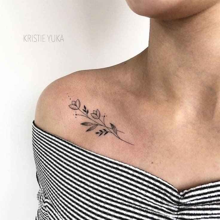 a woman with a small tattoo on her shoulder