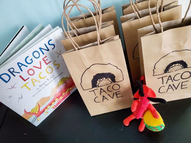 three bags with taco cave designs on them and a stuffed animal in the middle