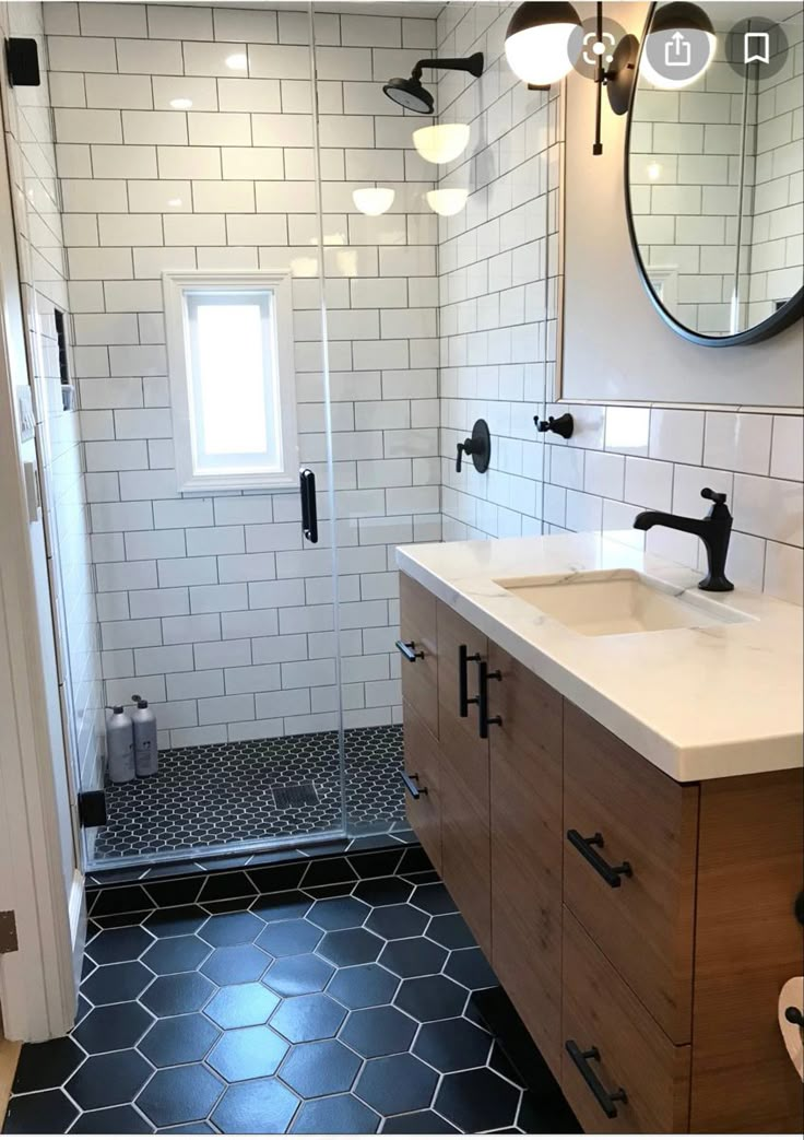 a bathroom with black and white tile flooring