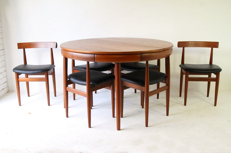 a wooden table with four chairs around it