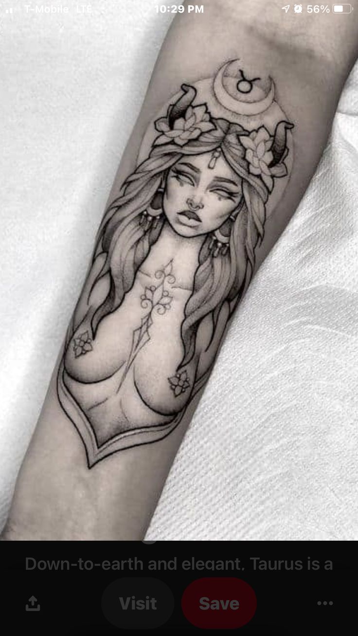 a woman's arm with a tattoo on it and flowers in her hair,