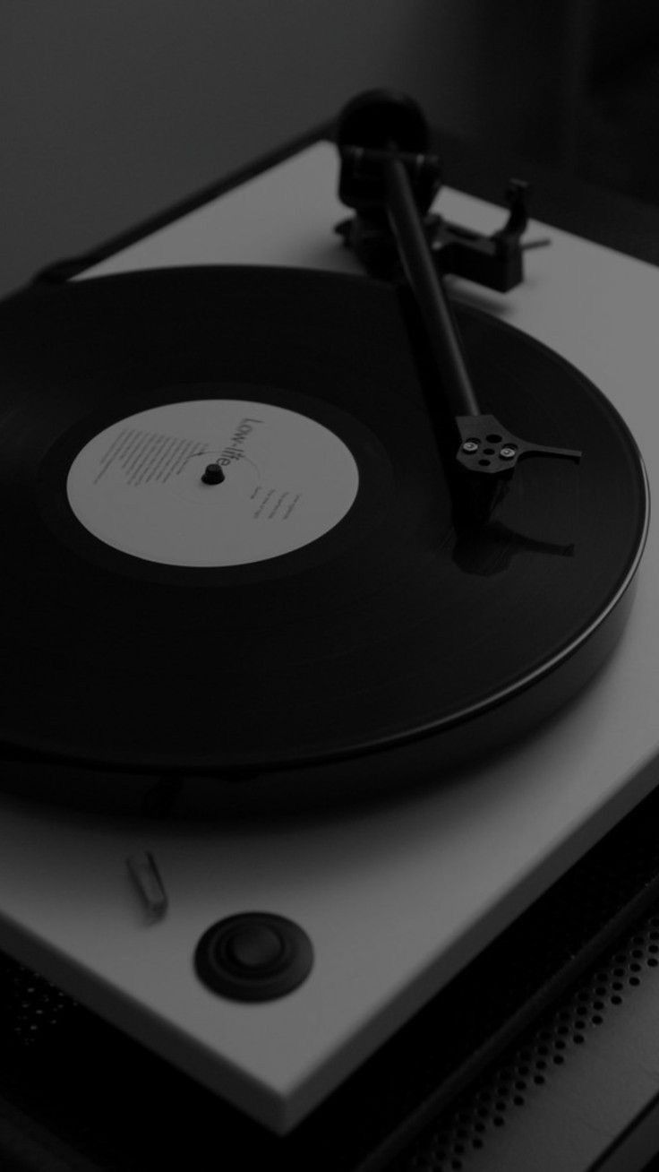 an old record player sitting on top of a turntable in black and white photo