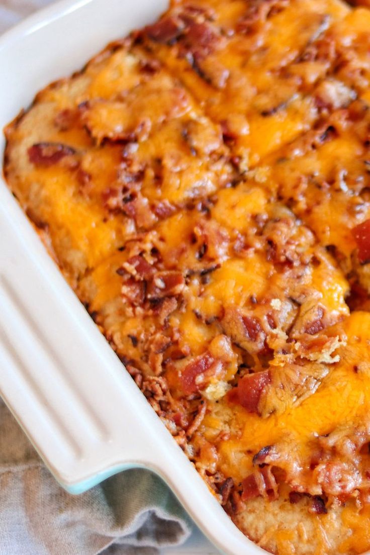 a casserole dish with cheese and bacon on top