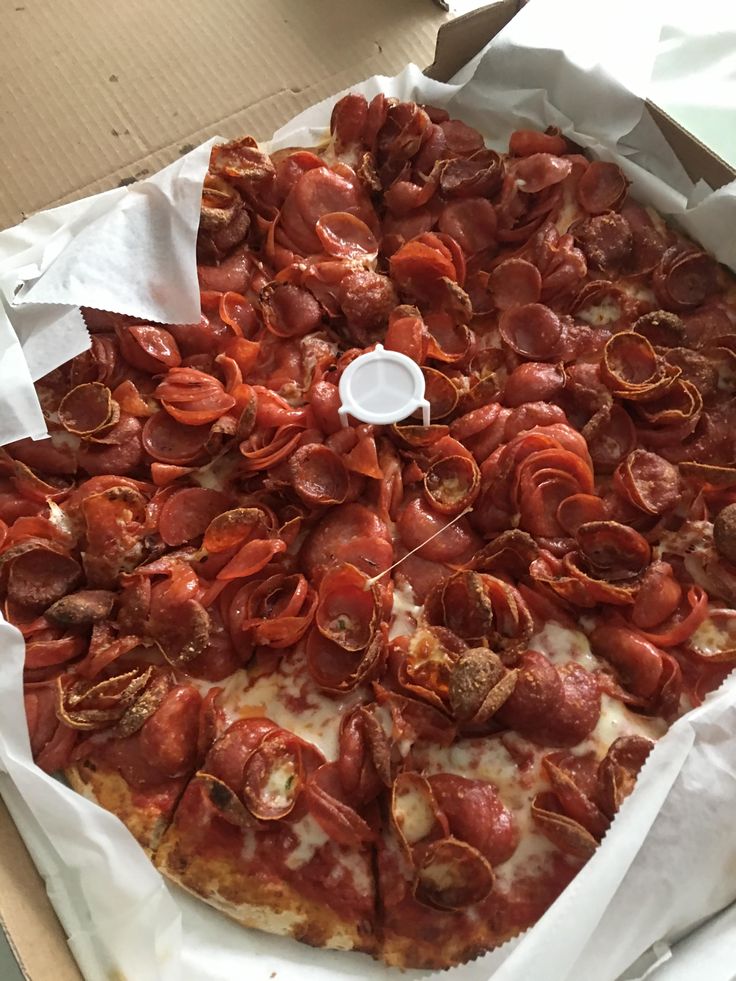 there is a pizza with lobsters on it in the box and ready to be eaten