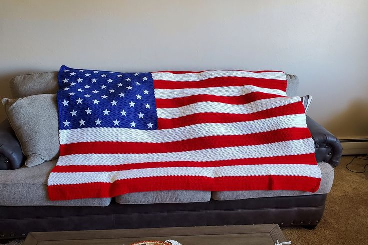 an american flag blanket is draped over a couch