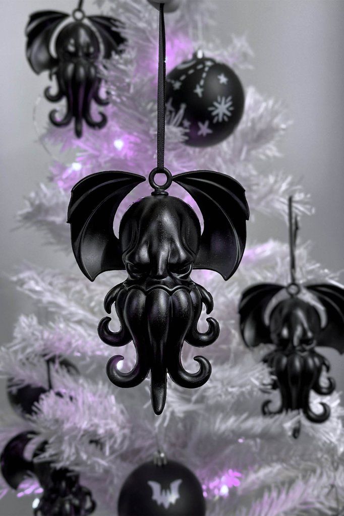 a black and white christmas tree with bats hanging from it