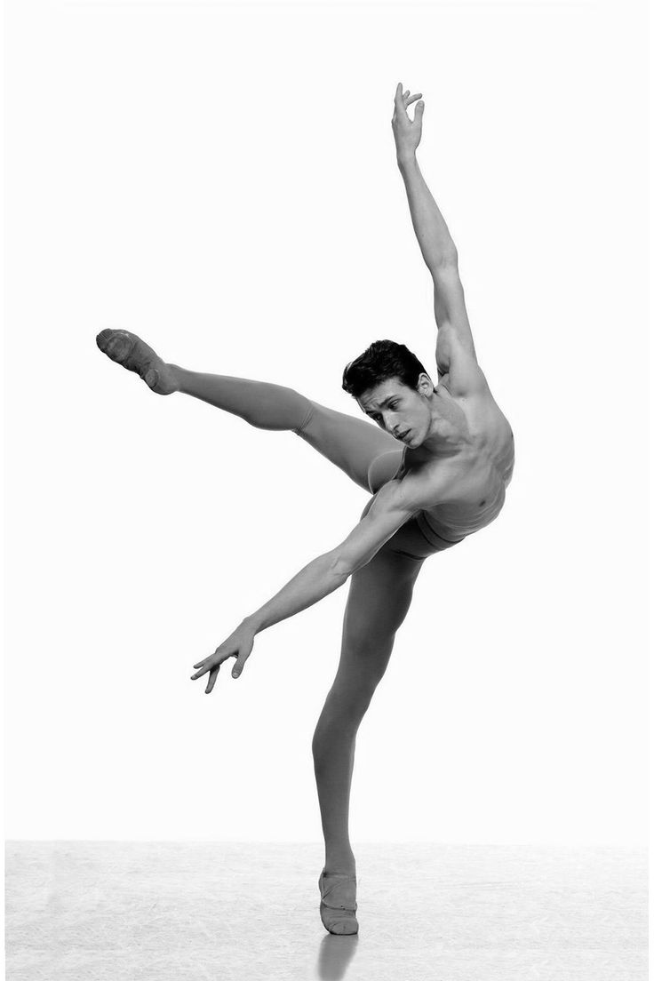 a shirtless man is doing an acrobatic move