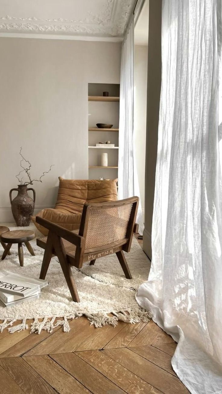 a living room filled with furniture and white curtains