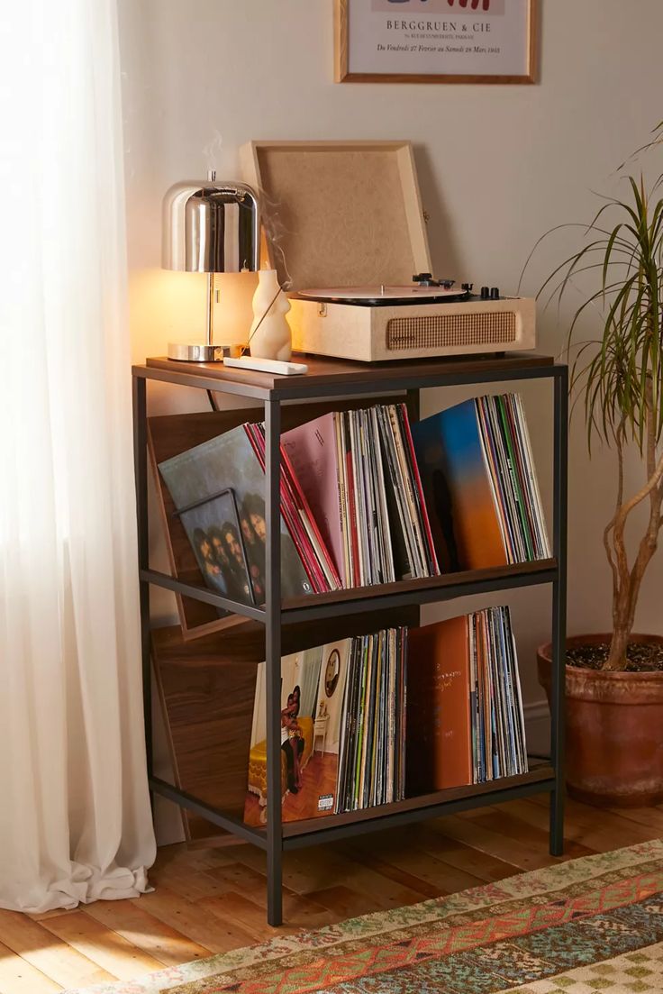 a record player sitting on top of a book shelf