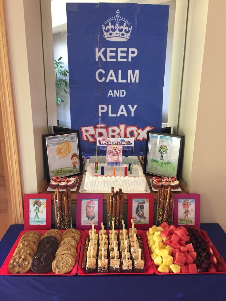 a table topped with lots of different types of desserts and pastries next to a sign that says keep calm and play