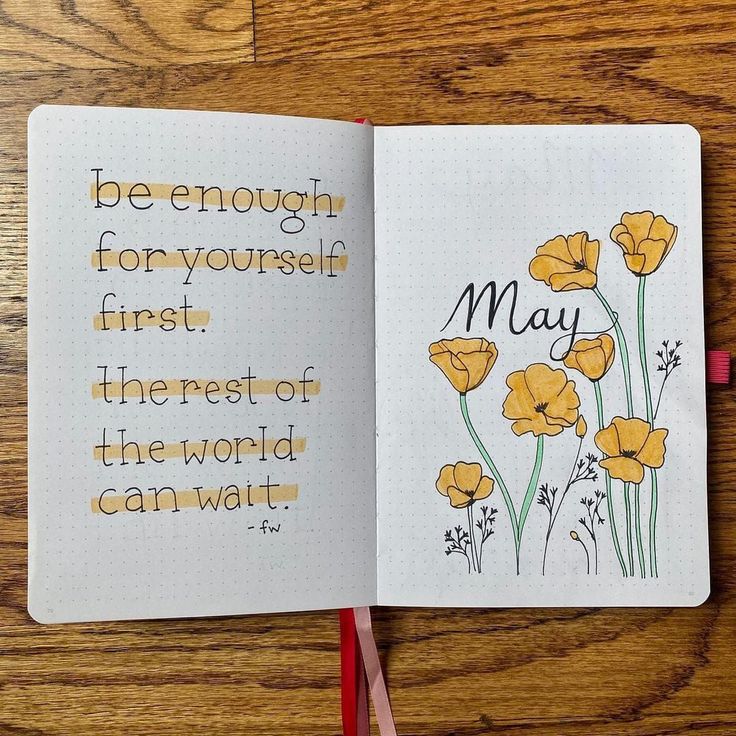 an open notebook with yellow flowers and the words may written in cursive writing