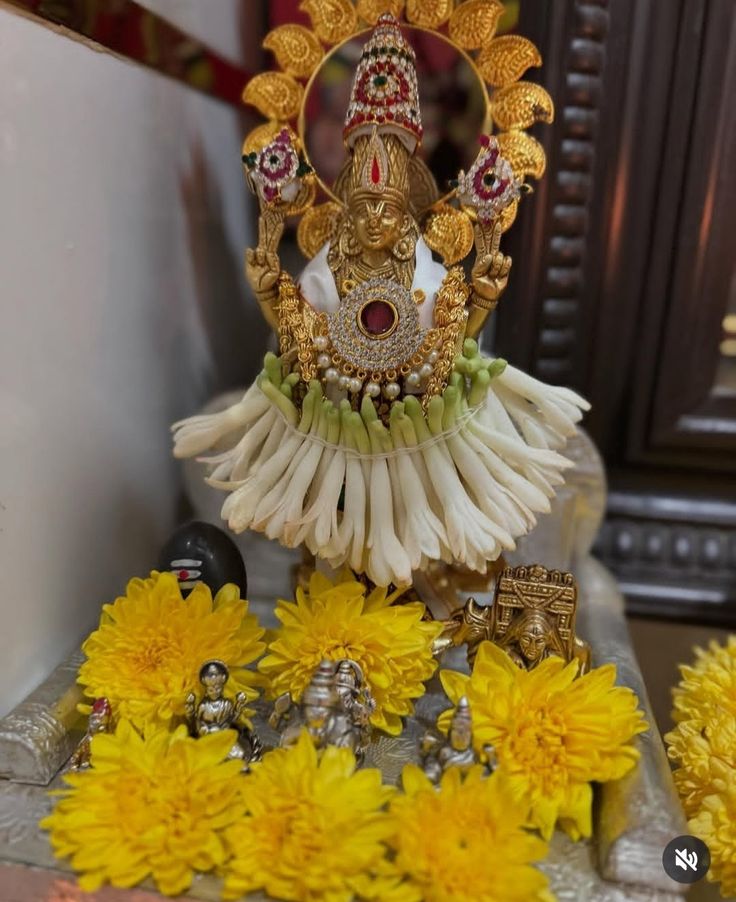 the statue is surrounded by flowers and other decorations