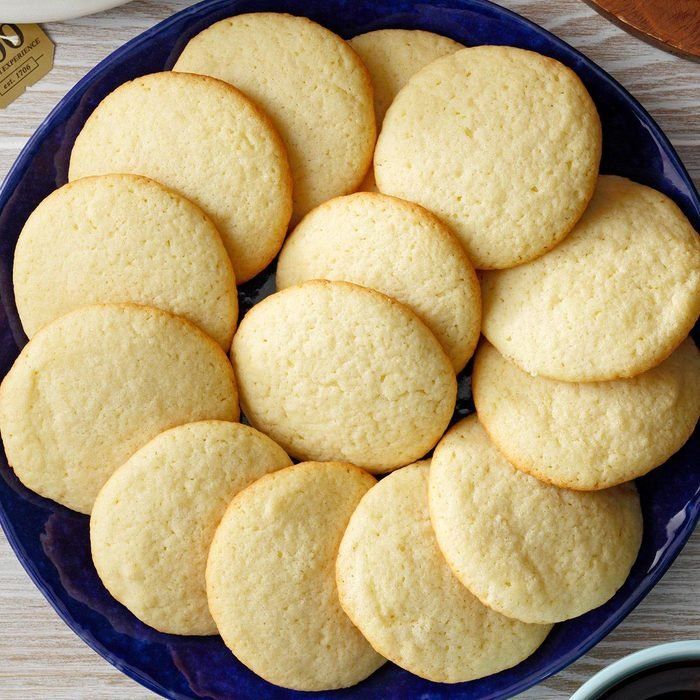 a blue plate filled with cookies on top of a wooden table