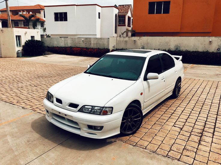 a white car parked in front of some houses