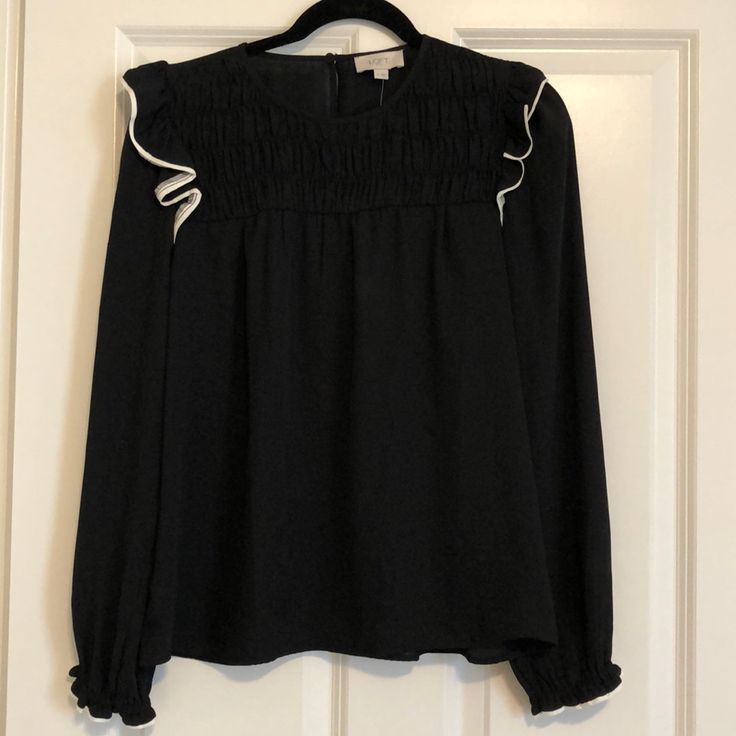 Nwt Loft Outlet Black Smocked Ruffle Top, Sz S. Pull On Styling, Back Closure Button. Smocked Detail At Bust. Elastic Ruffle At Wrist. Ruffle At Shoulder. Shoulder-Hem 23”, Shoulder Length 24” Black Smocked Top With Ruffles For Spring, Chic Long Sleeve Smocked Top For Work, Chic Smocked Top With Ruffles For Fall, Black Blouse With Smocked Back For Fall, Black Smocked Blouse For Fall, Casual Black Blouse With Smocked Cuffs, Black Ruffled Smocked Top For Spring, Black Smock Blouse For Fall, Black Blouse With Smocked Back For Spring