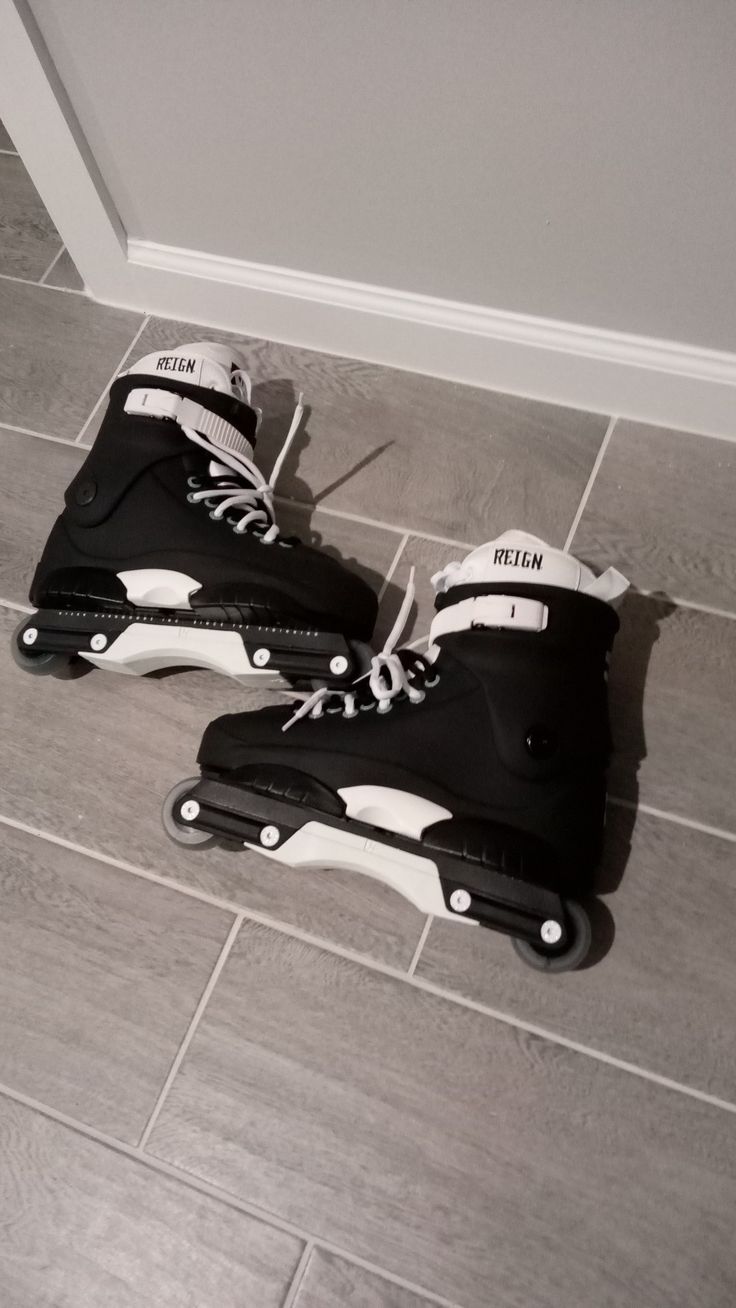 two pairs of roller skates sitting on the floor