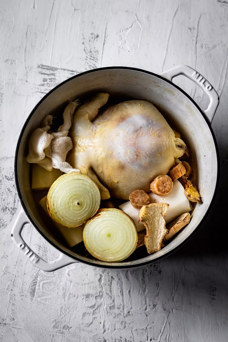 a pot filled with meat and vegetables on top of a table