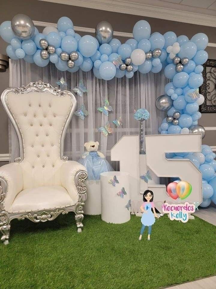 a balloon arch is decorated with blue and silver balloons for a princess themed birthday party