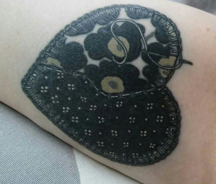 a close up of a person with a tattoo on their arm