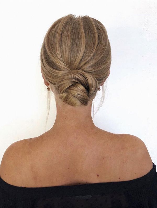 a woman with blonde hair in a low bun