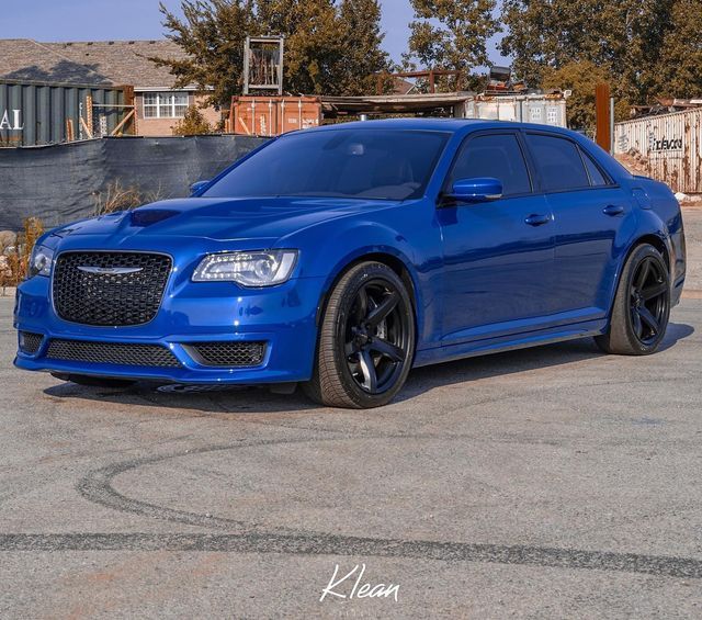 a blue car parked in a parking lot