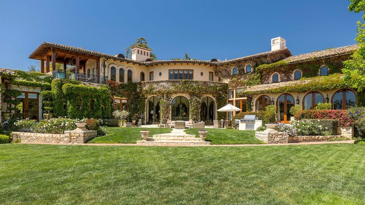 a large house with lots of windows and landscaping