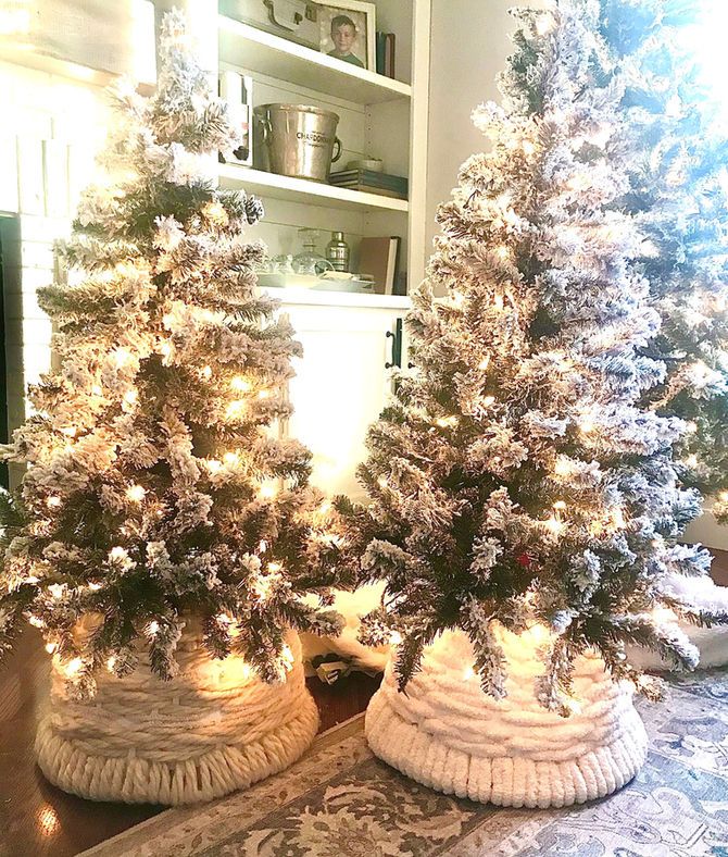 two white christmas trees sitting on top of a table