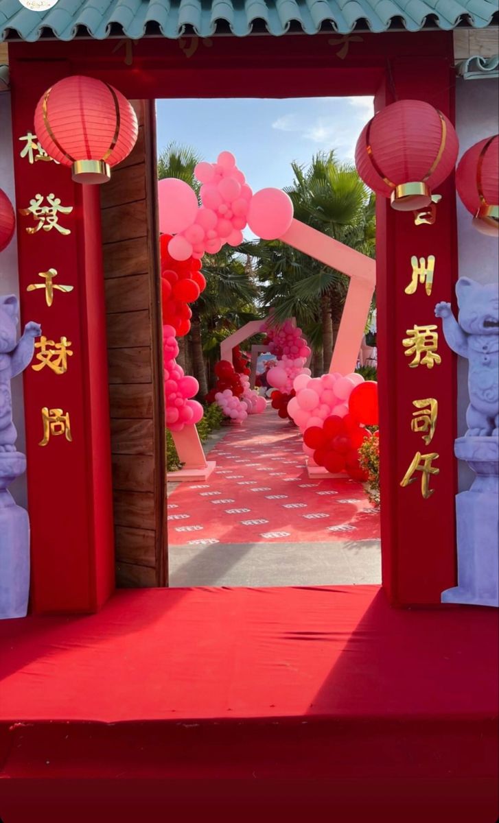 an entrance to a chinese garden with lanterns and decorations