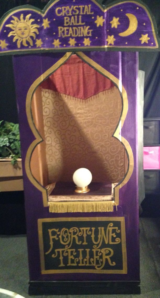 the fortune teller machine is purple with gold trimmings and a white ball on top