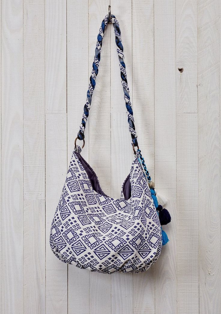 Add a bohemian touch to your ensemble with our mixed media hobo bag in hues of blue. Featuring a snap closure, a twisted strap, and a multi-tassel accent. A fashionable slouchy purse that's perfect for everyday use. Slouchy style bag Mixed media Single snap closure Twisted strap Multi tassel detail Beaded embellishments Dimensions: W: 19 in x H: 12 inStyle: DR-1929 Bohemian Bucket Bag With Braided Handles For Everyday, Bohemian Summer Hobo Bag With Removable Pouch, Bohemian Hobo Bag With Removable Pouch For Summer, Bohemian Bucket Bag With Adjustable Strap For Everyday, Bohemian Hobo Bag With Adjustable Strap, Bohemian Hobo Bag With Braided Handles For Daily Use, Blue Tassel Bags For Daily Use, Bohemian Hobo Bag With Braided Handles For Travel, Blue Fringe Bags For Daily Use