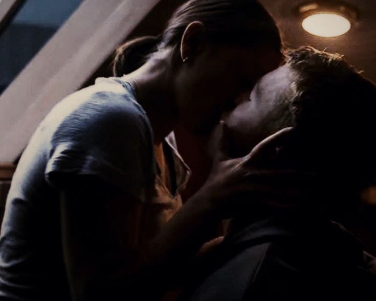 two people kissing each other in the dark