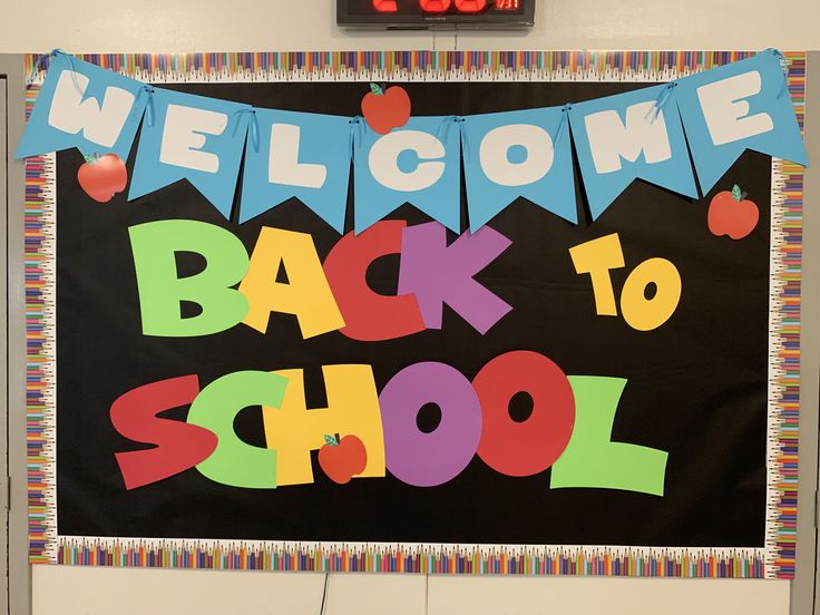 a welcome back to school sign hanging on the wall