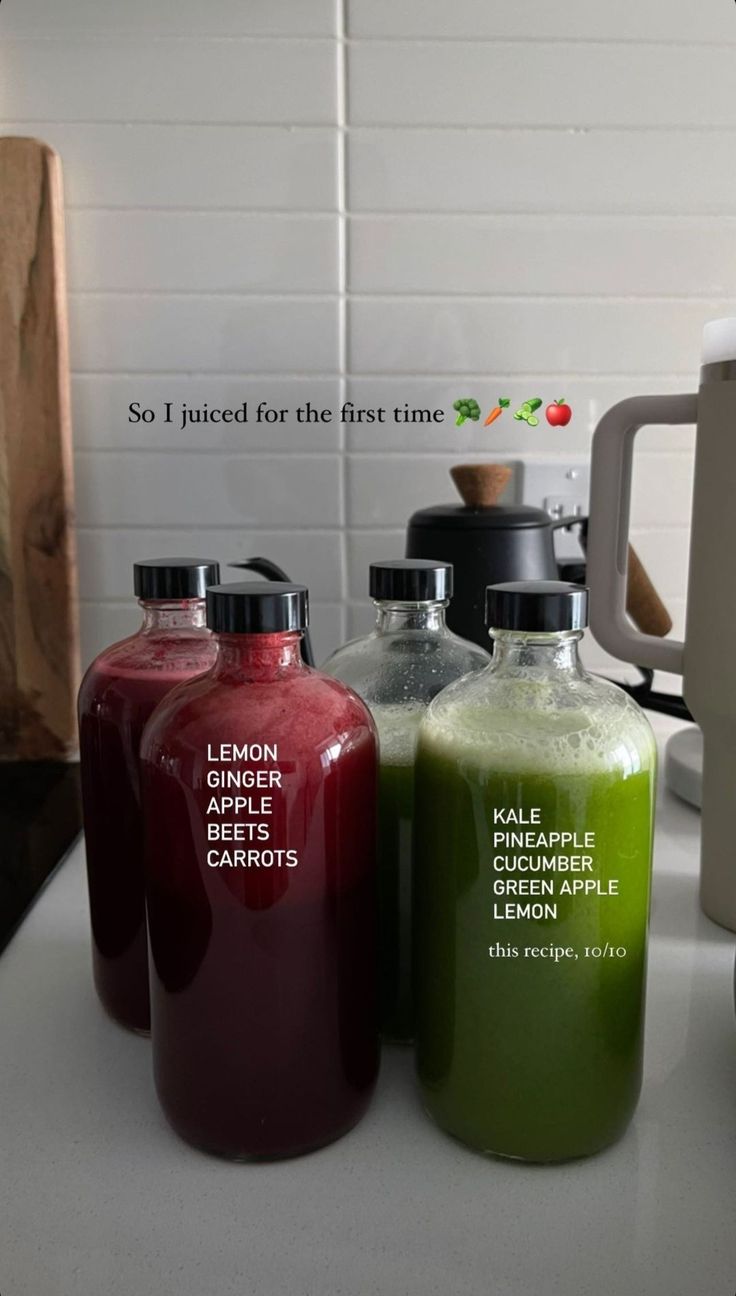 three different types of juices sitting on a counter