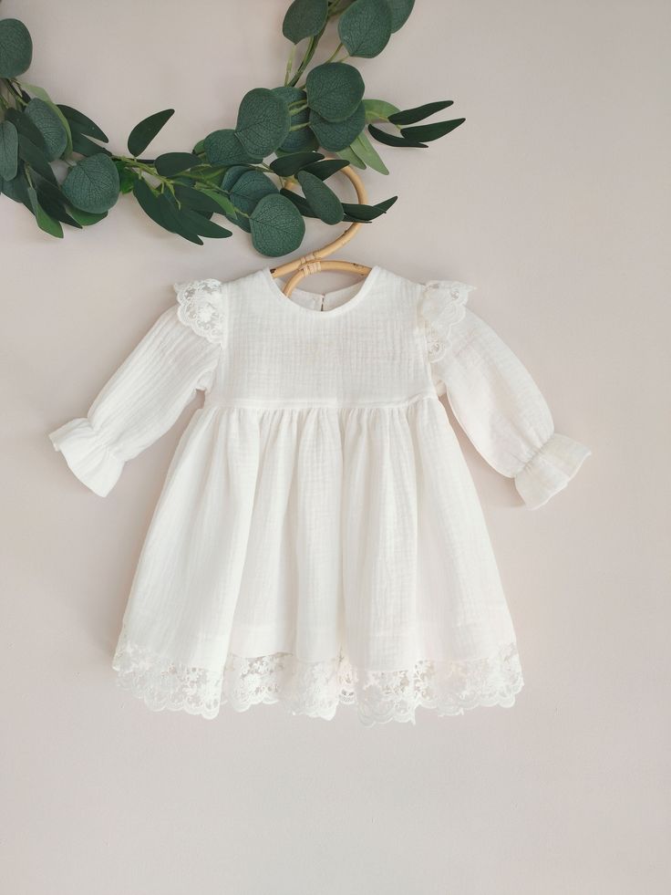 ♡ This is handmade and unique girl dress below knee-length and with long sleeves.  It is breathable, natural, comfortable to wear on special occasions. ♡ MADE OF: Ecru double gaze muslin with ecru lace (it's pure 100% ECO Organic Cotton) and wooden button. ♡ Processing time: ready to ship.  ♡ CARE INSTRUCTIONS: Wash in cold or warm water (30oC/ 65 - 85F). Do not use bleach. Dry at low temperatures, do not use machine drying. Iron at medium or low temperature. Hand wash and hang dry for longer we Off-white Lace Dress For Baptism, Off White Lace Dress For Baptism, Spring Baptism Dress With Long Sleeves And Ruffles, Spring Long Sleeve Baptism Dress With Ruffles, Spring Long Sleeve Ruffle Baptism Dress, Cream Ruffled Lace Dress For Baptism, White Ruffled Lace Dress For First Communion, Cream Lace Ruffle Dress For Baptism, White Lace Dress With Ruffles For First Communion