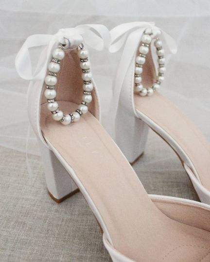 Satin block heel with pearl ankle strap. Beautiful and yet looks fun and dramatic.DETAILS:HEEL HEIGHT: 3 inchesCOLORS AVAILABLE: Champagne, White, Ivory, Navy, Burgundy, and Light BlueUPPER: Synthetic upper and liningMATERIALS: Mandmade outsoleSTYLE NAME: SARAH Heels With Pearls, Bride Heels, Pearl Wedding Shoes, Ivory Bridal Shoes, Lace Sandals, Wedding Shoes Bride, Holiday Shoes, Ankle Sandals, Pointy Toe Heels