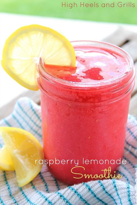 a close up of a mason jar filled with liquid and lemons on a towel