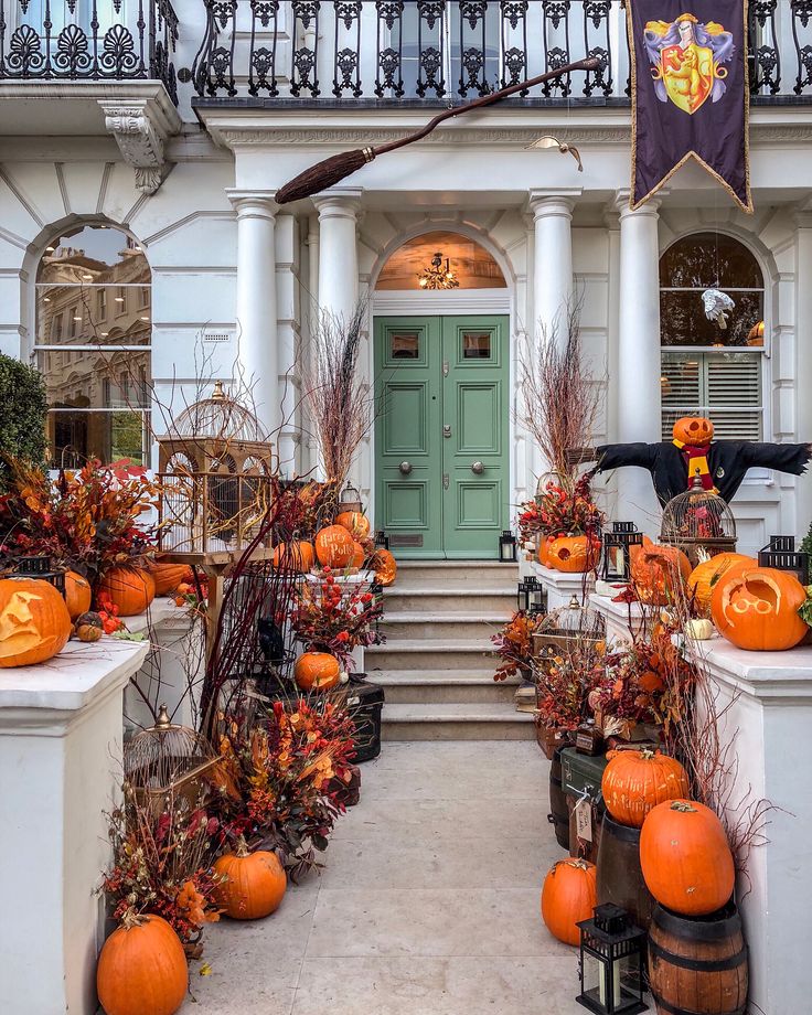 a house with pumpkins and decorations on the front porch