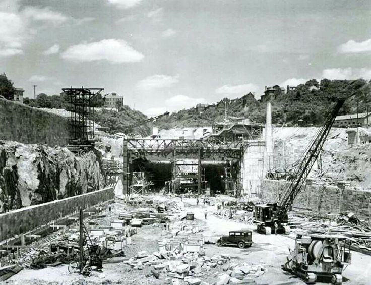 an old black and white photo of construction in the middle of a large quarry area